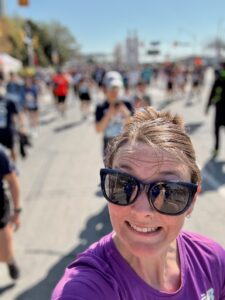 A selfie of me, Sarah, at the finish line of a 10k running race.